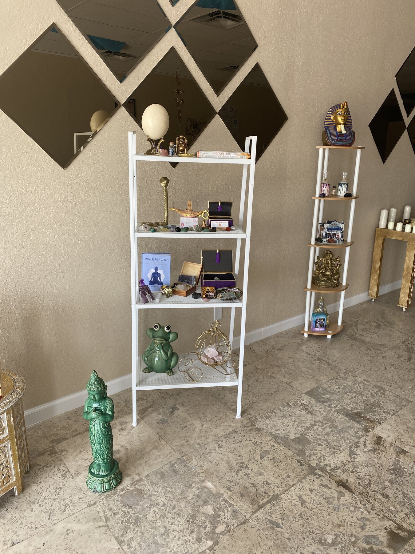 Spiritual altar with statues, crystals, and ritual objects